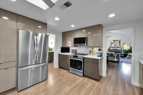 a kitchen with stainless steel appliances kitchen island granite countertop a sink and cabinets