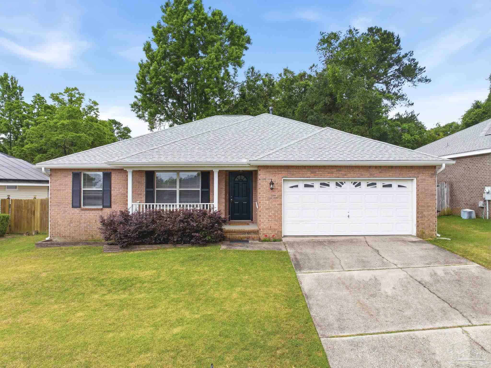 10120 Crest Ridge Drive Pensacola, FL 32514 - Photo 1 of 38 a view of a house with a garden and yard