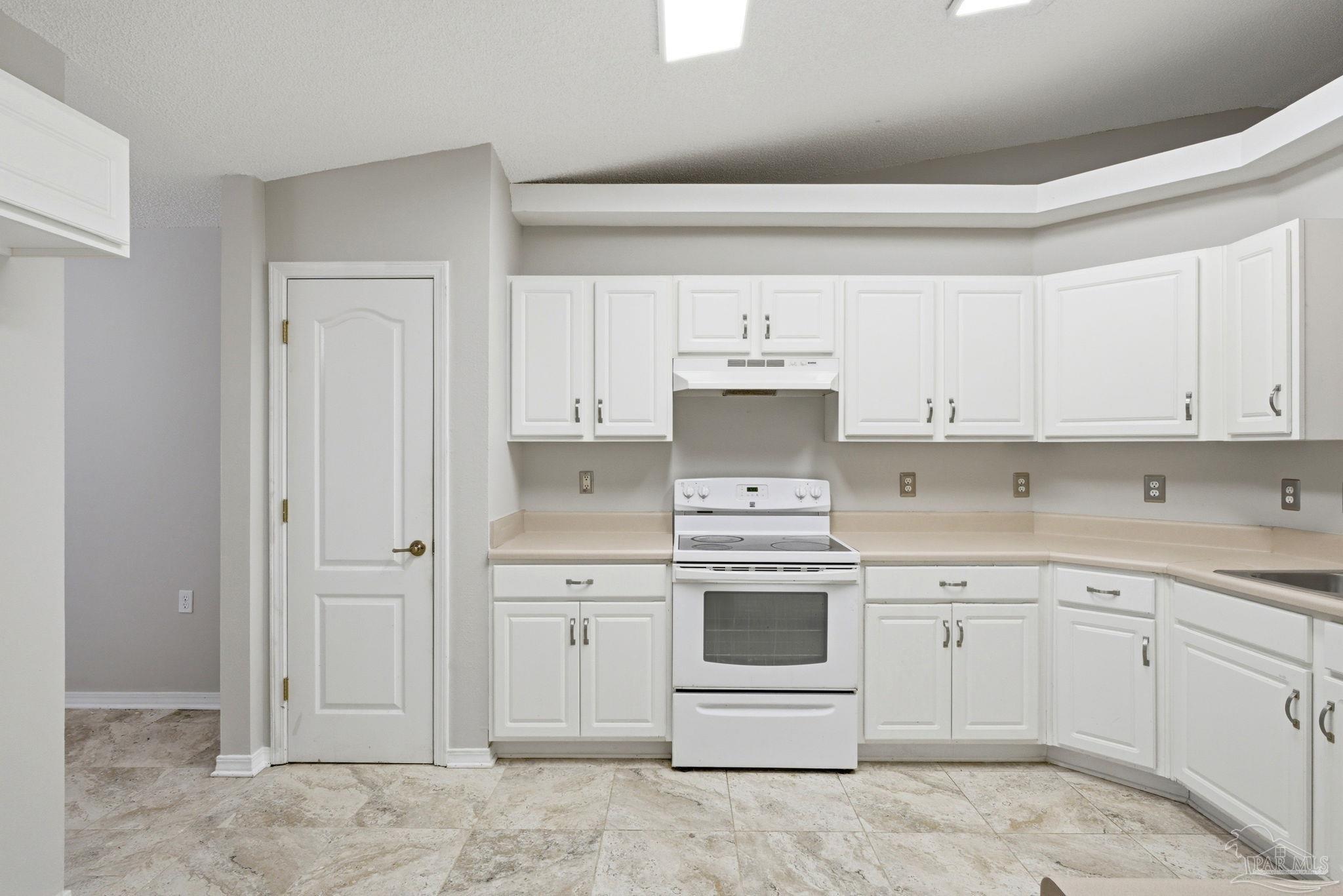 10120 Crest Ridge Drive Pensacola, FL 32514 - Photo 11 of 38 a kitchen with white cabinets stainless steel appliances and sink