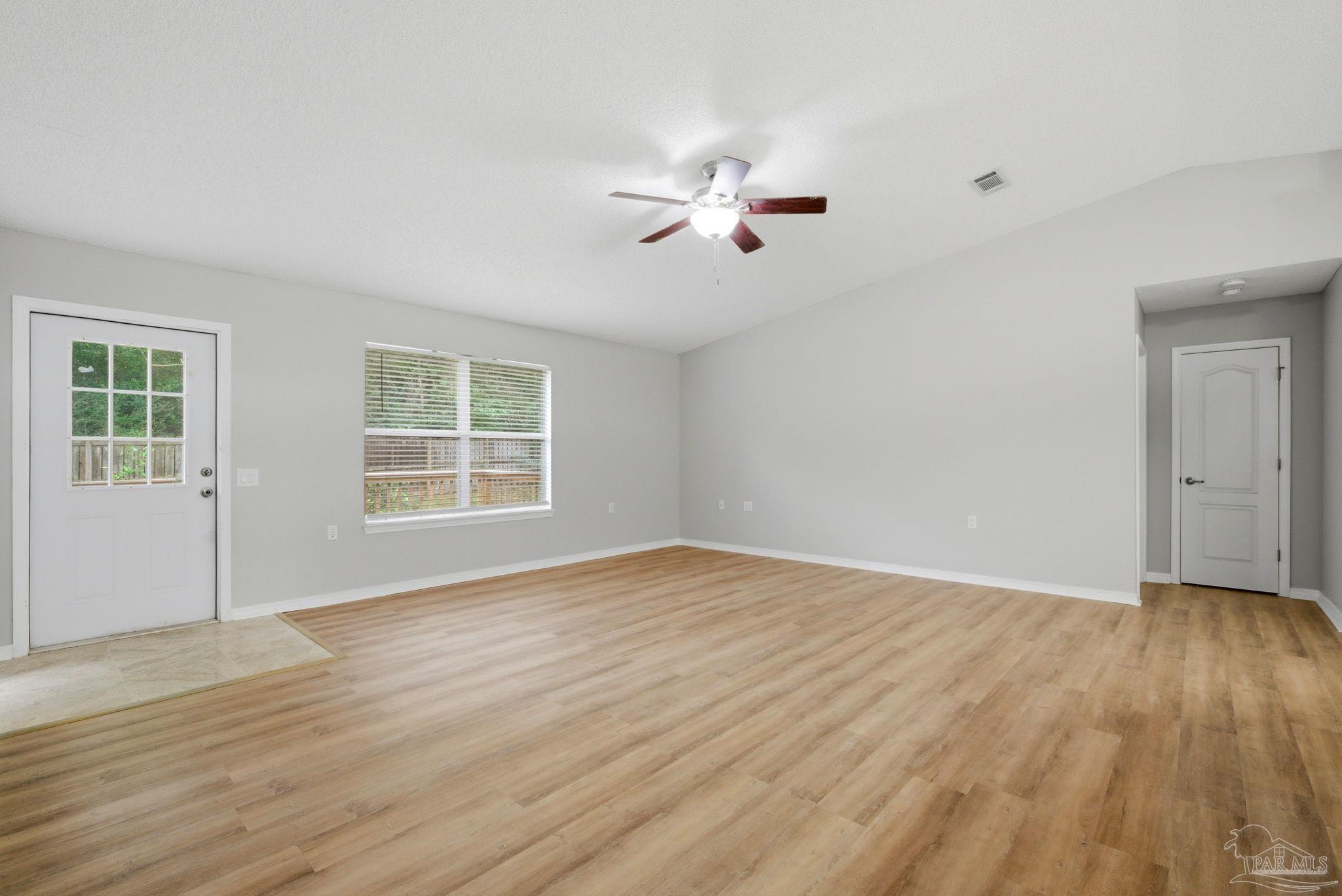 10120 Crest Ridge Drive Pensacola, FL 32514 - Photo 15 of 38 a view of empty room with wooden floor and fan