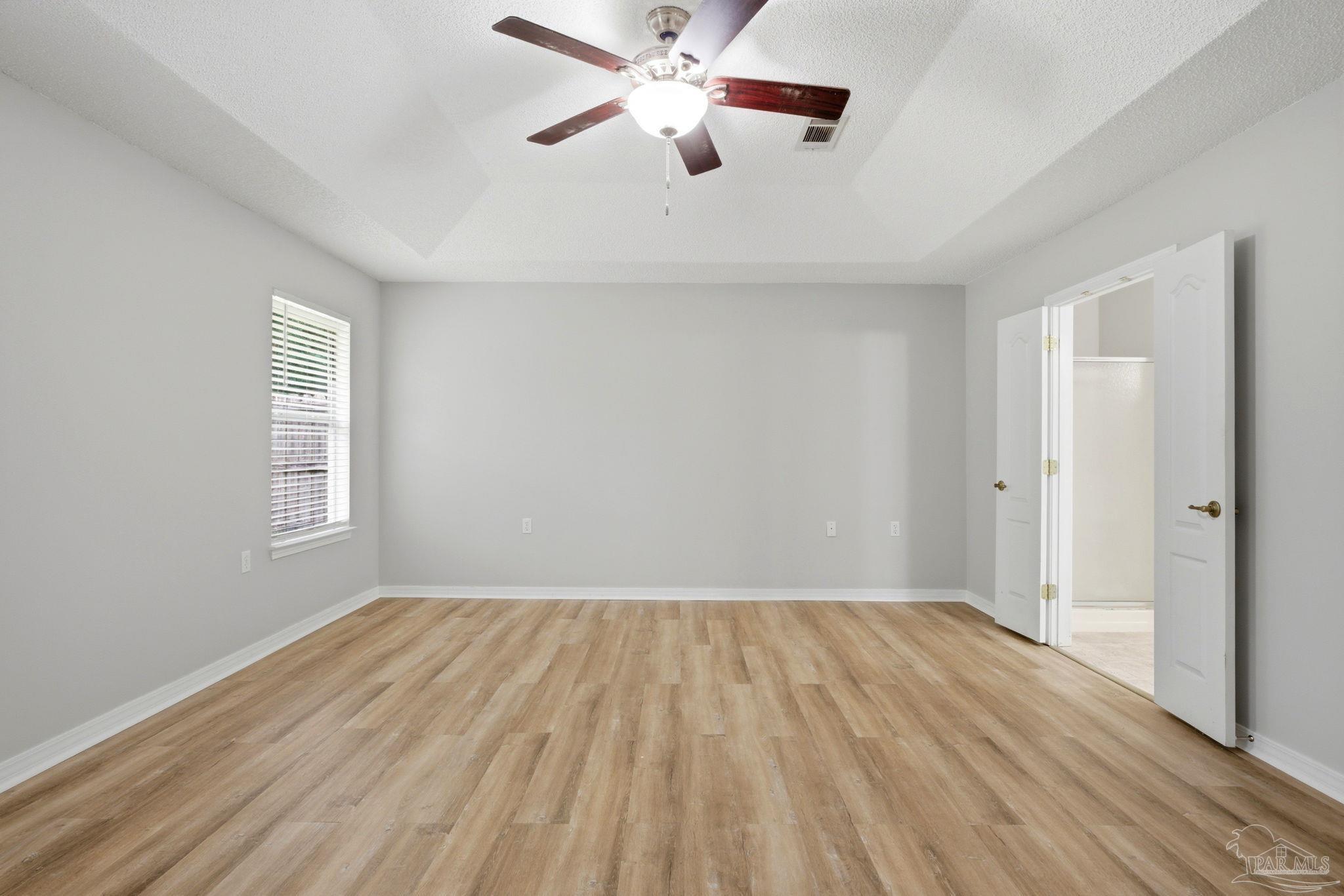 10120 Crest Ridge Drive Pensacola, FL 32514 - Photo 16 of 38 wooden floor in an empty room with a window