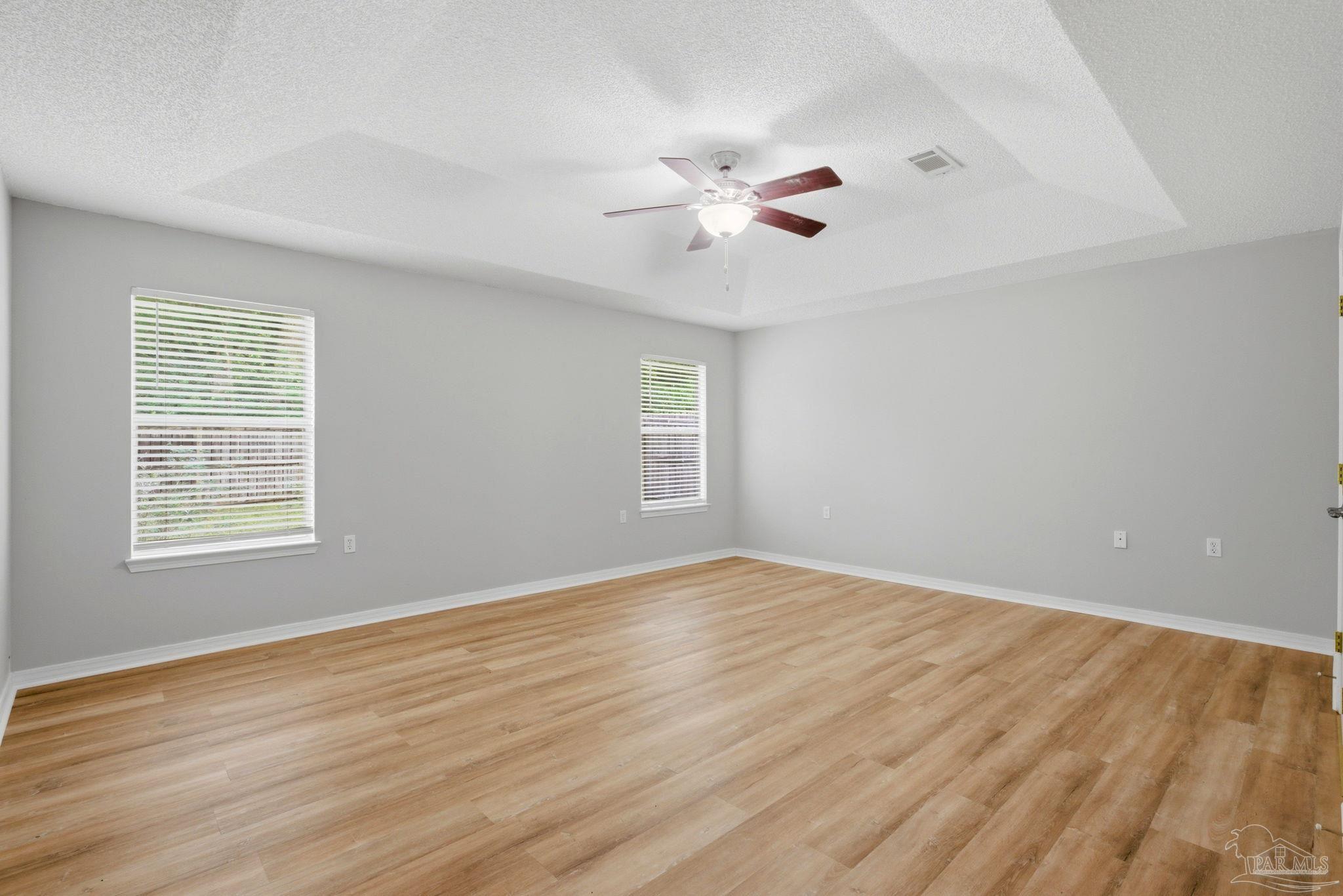 10120 Crest Ridge Drive Pensacola, FL 32514 - Photo 17 of 38 wooden floor in an empty room with a window