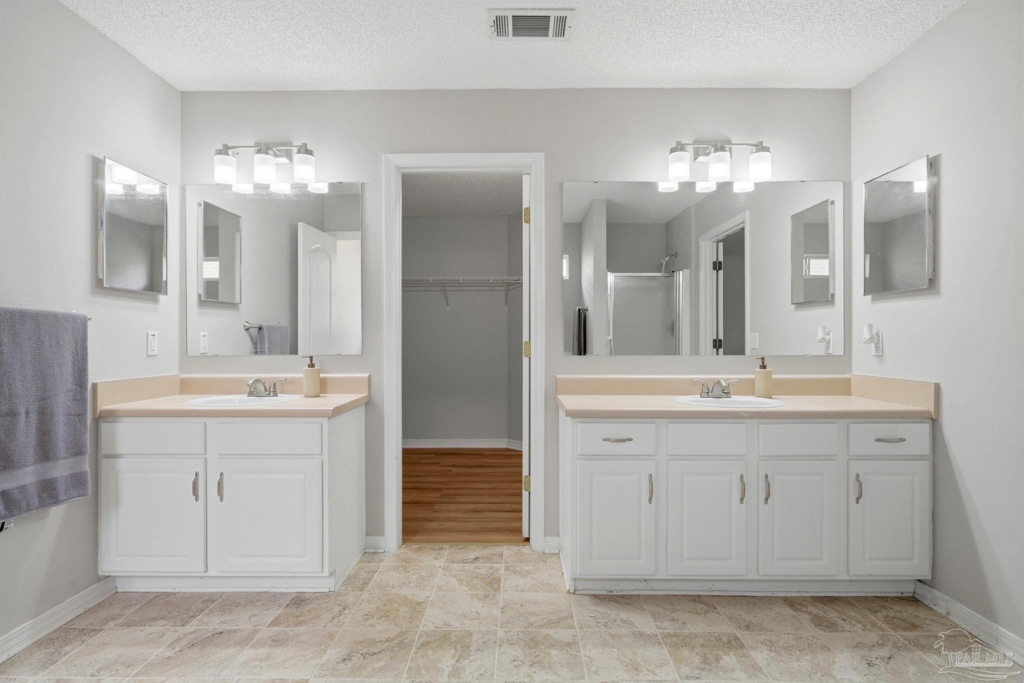 10120 Crest Ridge Drive Pensacola, FL 32514 - Photo 20 of 38 a bathroom with a double vanity sink and a mirror