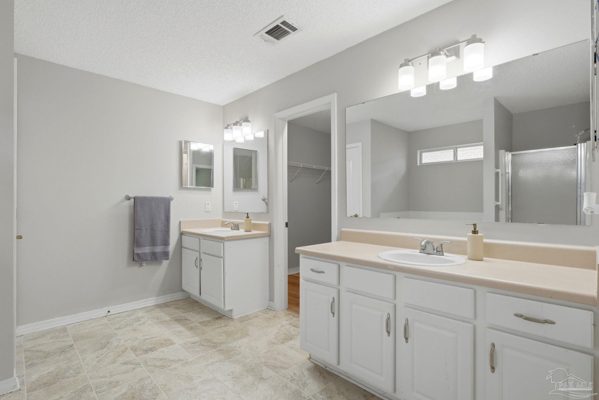 10120 Crest Ridge Drive Pensacola, FL 32514 - Photo 22 of 38 a bathroom with a sink vanity and mirror