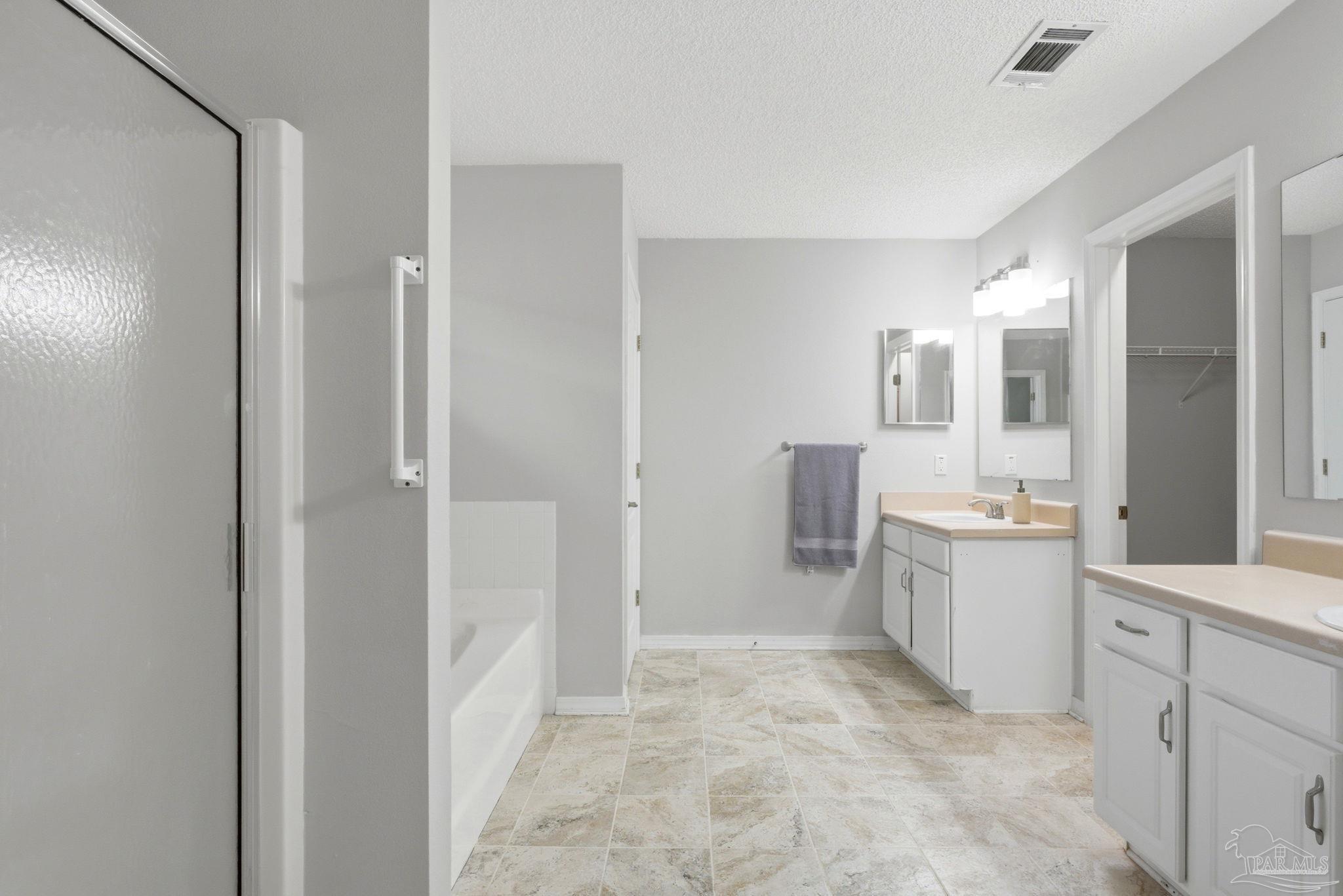 10120 Crest Ridge Drive Pensacola, FL 32514 - Photo 23 of 38 a large white room with a mirror and a sink