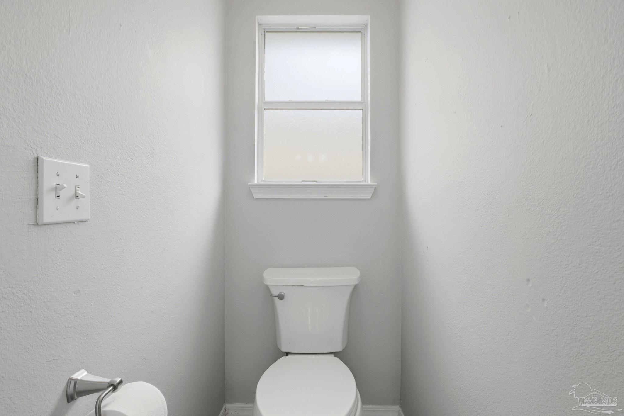 10120 Crest Ridge Drive Pensacola, FL 32514 - Photo 24 of 38 a white toilet sitting next to a window