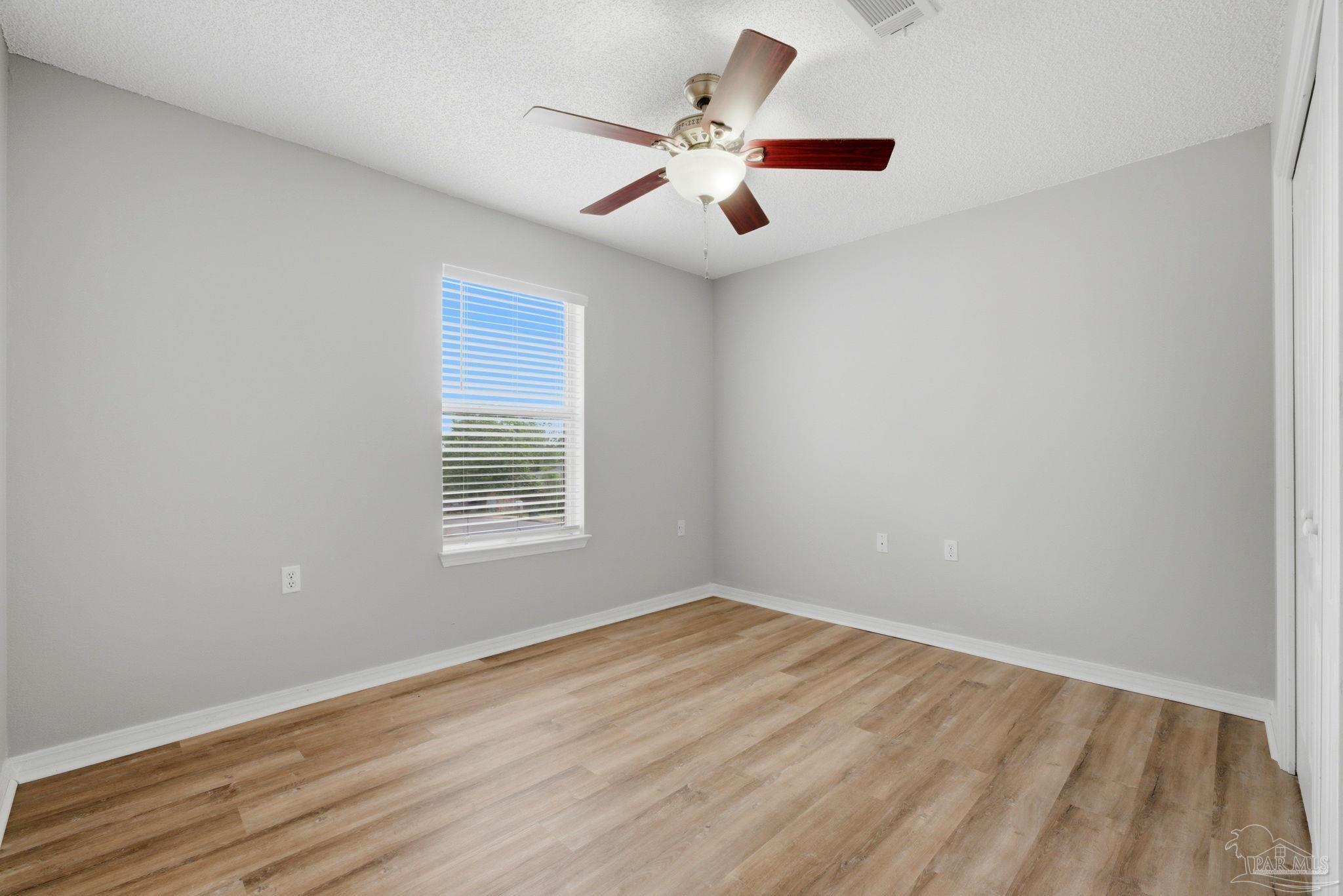 10120 Crest Ridge Drive Pensacola, FL 32514 - Photo 27 of 38 wooden floor in an empty room with a window
