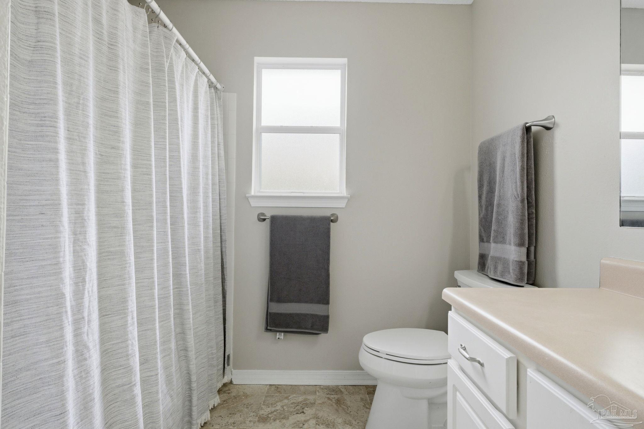 10120 Crest Ridge Drive Pensacola, FL 32514 - Photo 30 of 38 a white toilet sitting next to a bathroom sink
