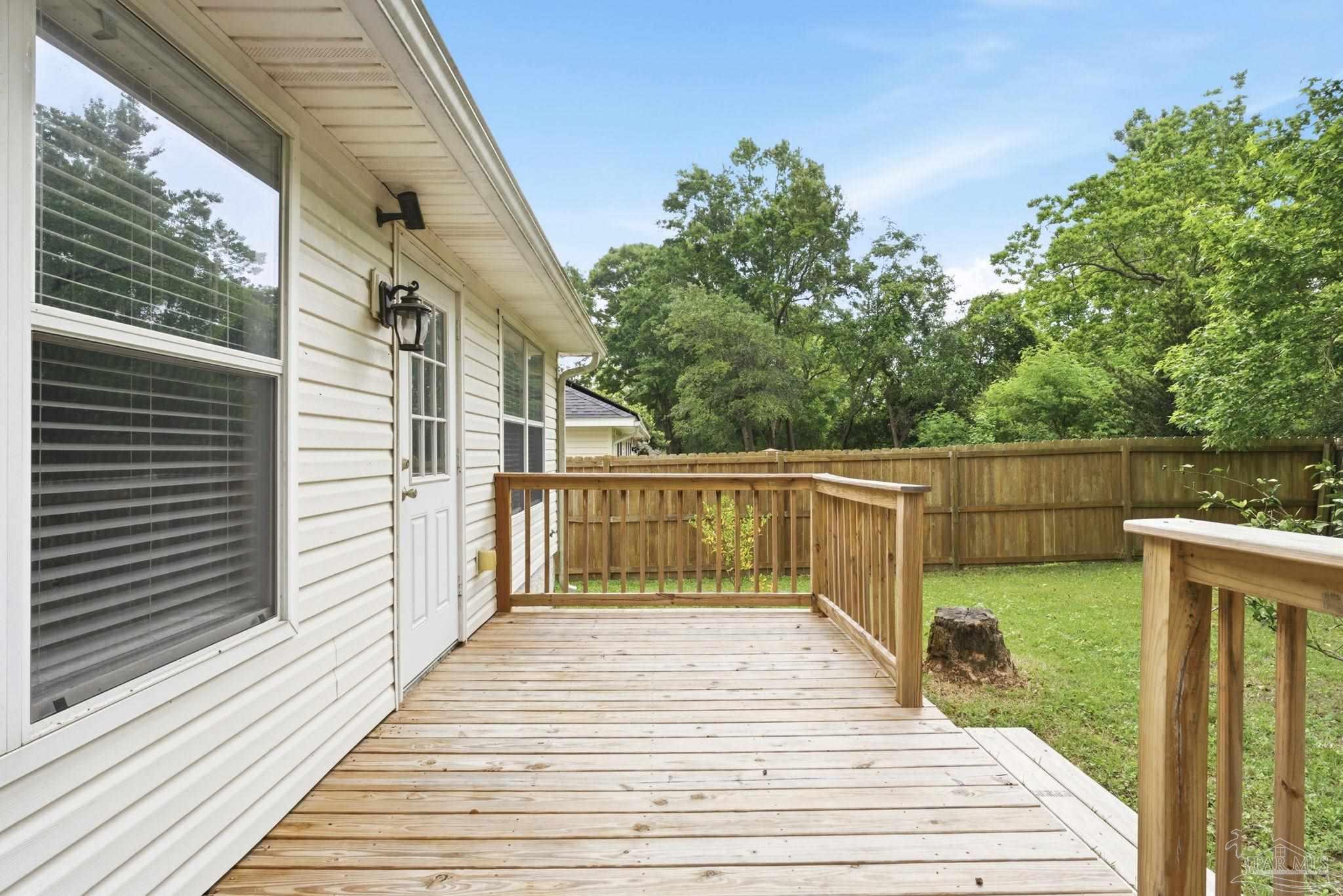 10120 Crest Ridge Drive Pensacola, FL 32514 - Photo 33 of 38 a balcony with wooden floor and yard in the back