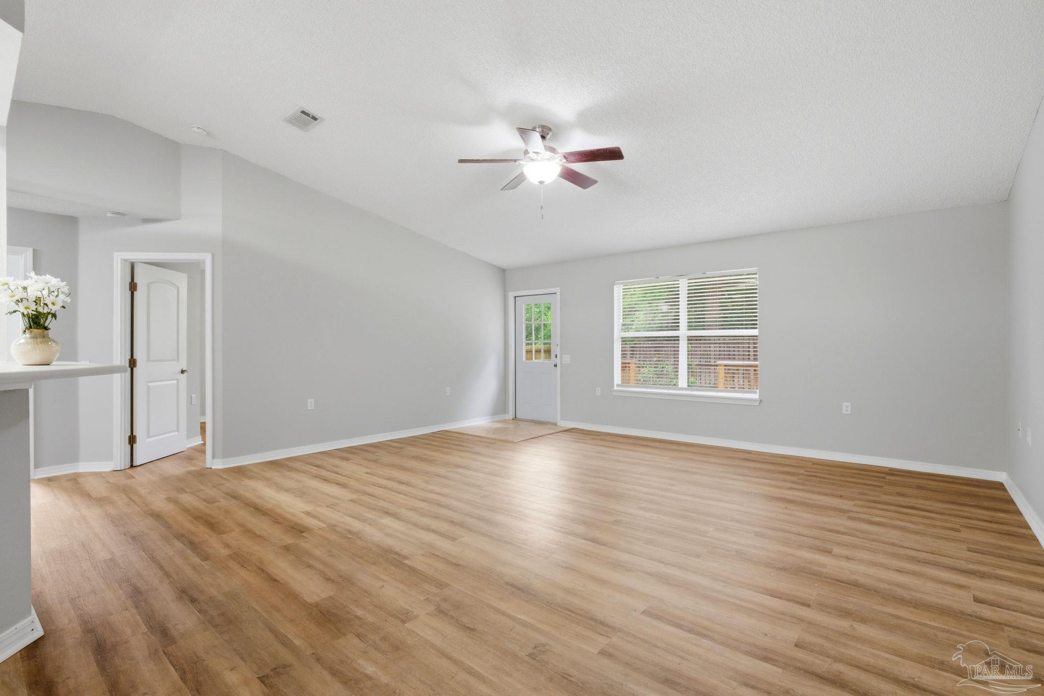 10120 Crest Ridge Drive Pensacola, FL 32514 - Photo 4 of 38 a view of empty room with wooden floor and fan