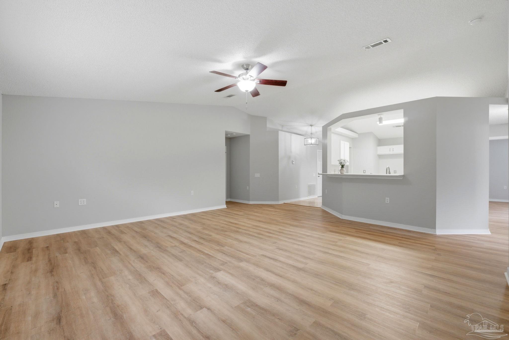 10120 Crest Ridge Drive Pensacola, FL 32514 - Photo 5 of 38 wooden floor in an empty room with a window