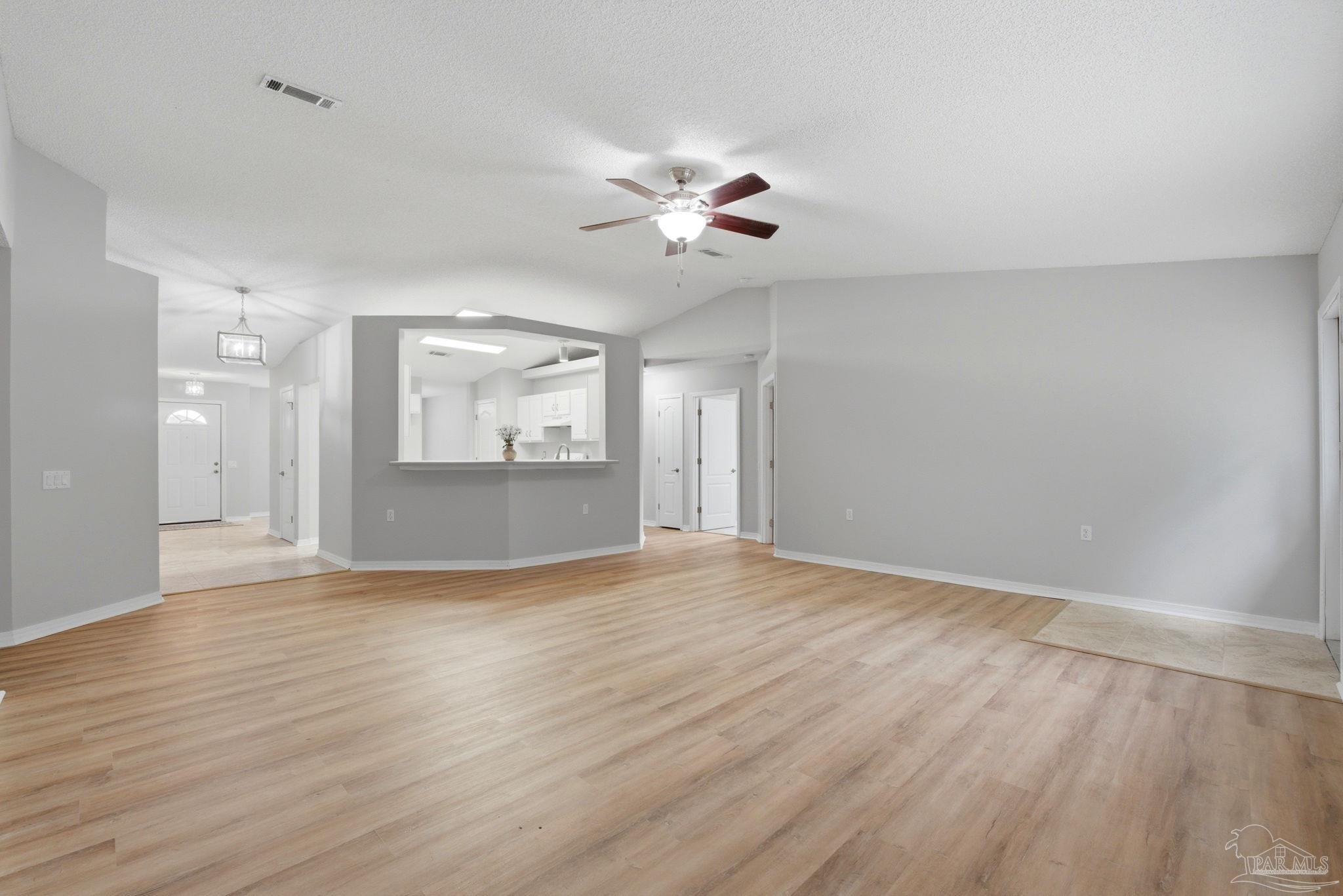10120 Crest Ridge Drive Pensacola, FL 32514 - Photo 6 of 38 a view of an empty room with a window and wooden floor