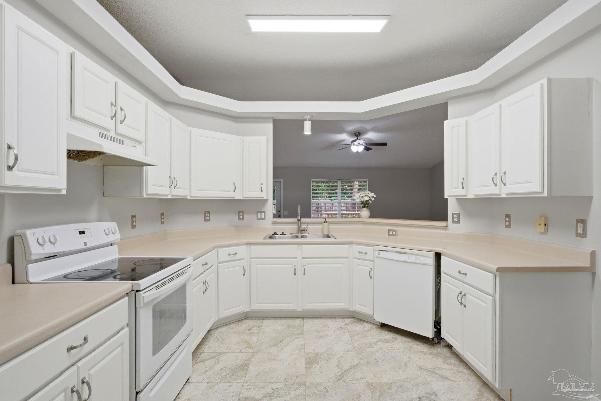 10120 Crest Ridge Drive Pensacola, FL 32514 - Photo 8 of 38 a kitchen with white cabinets sink and stove