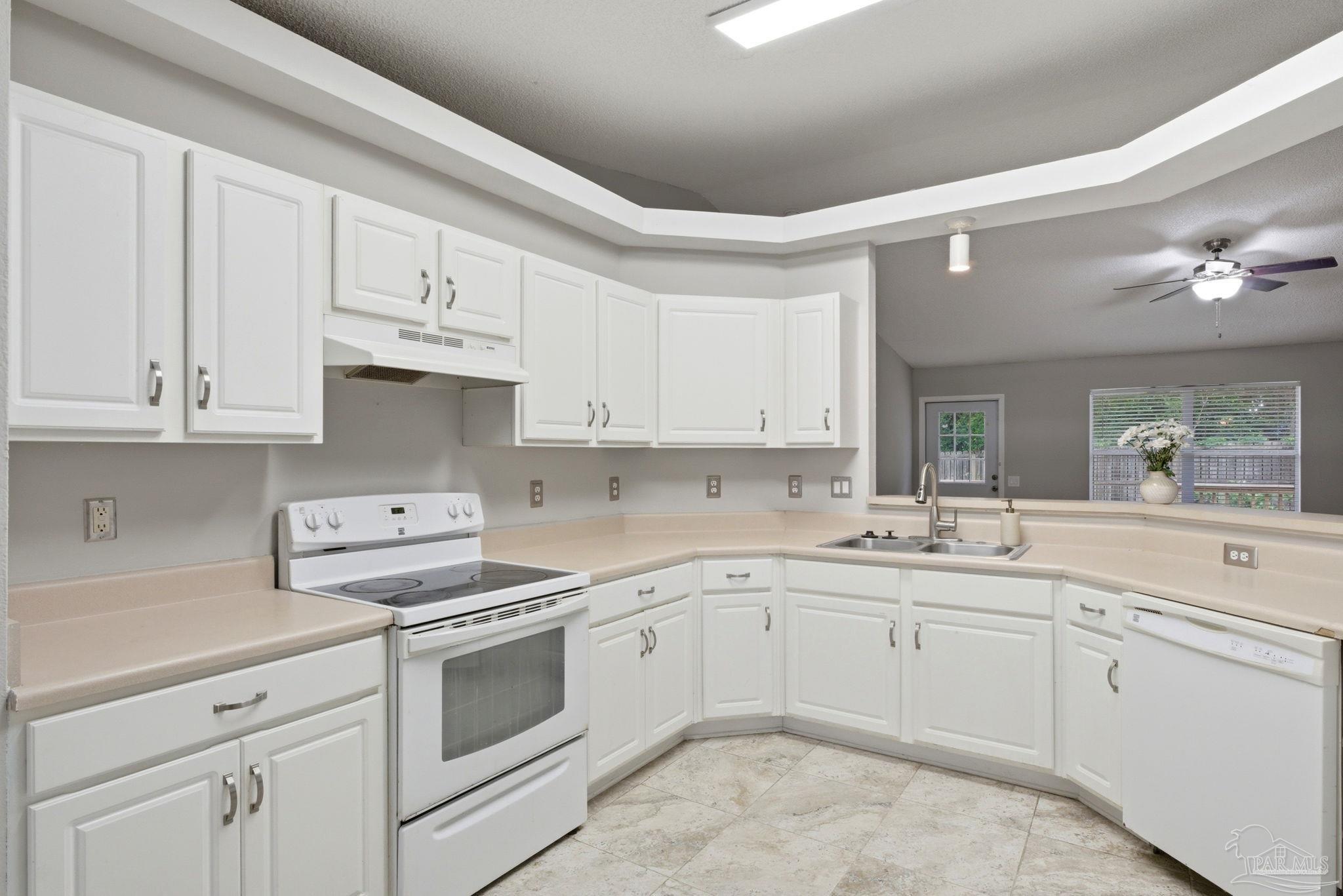 10120 Crest Ridge Drive Pensacola, FL 32514 - Photo 9 of 38 a kitchen with white cabinets and white appliances