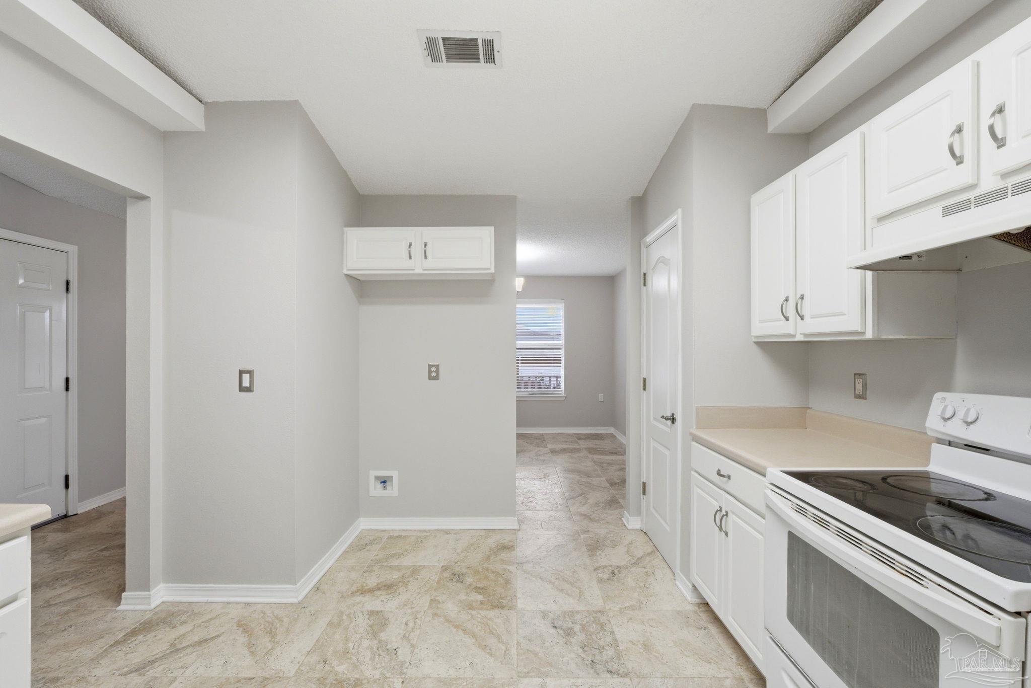 10120 Crest Ridge Drive Pensacola, FL 32514 - Photo 10 of 38 a kitchen with white cabinets and appliances