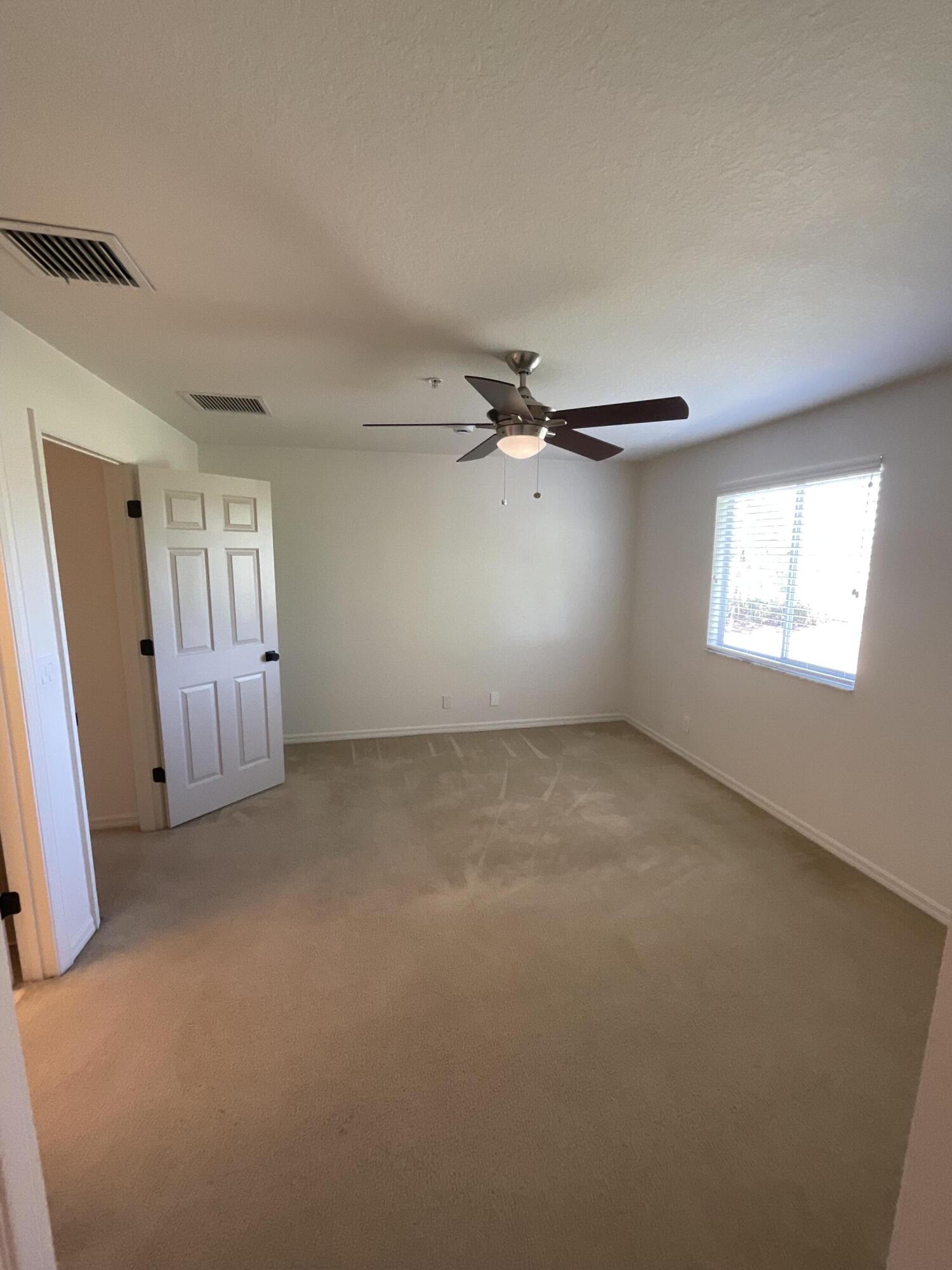 5269 Southeast Jennings Lane Stuart, FL 34997 - Photo 19 of 34 a view of empty room with windows