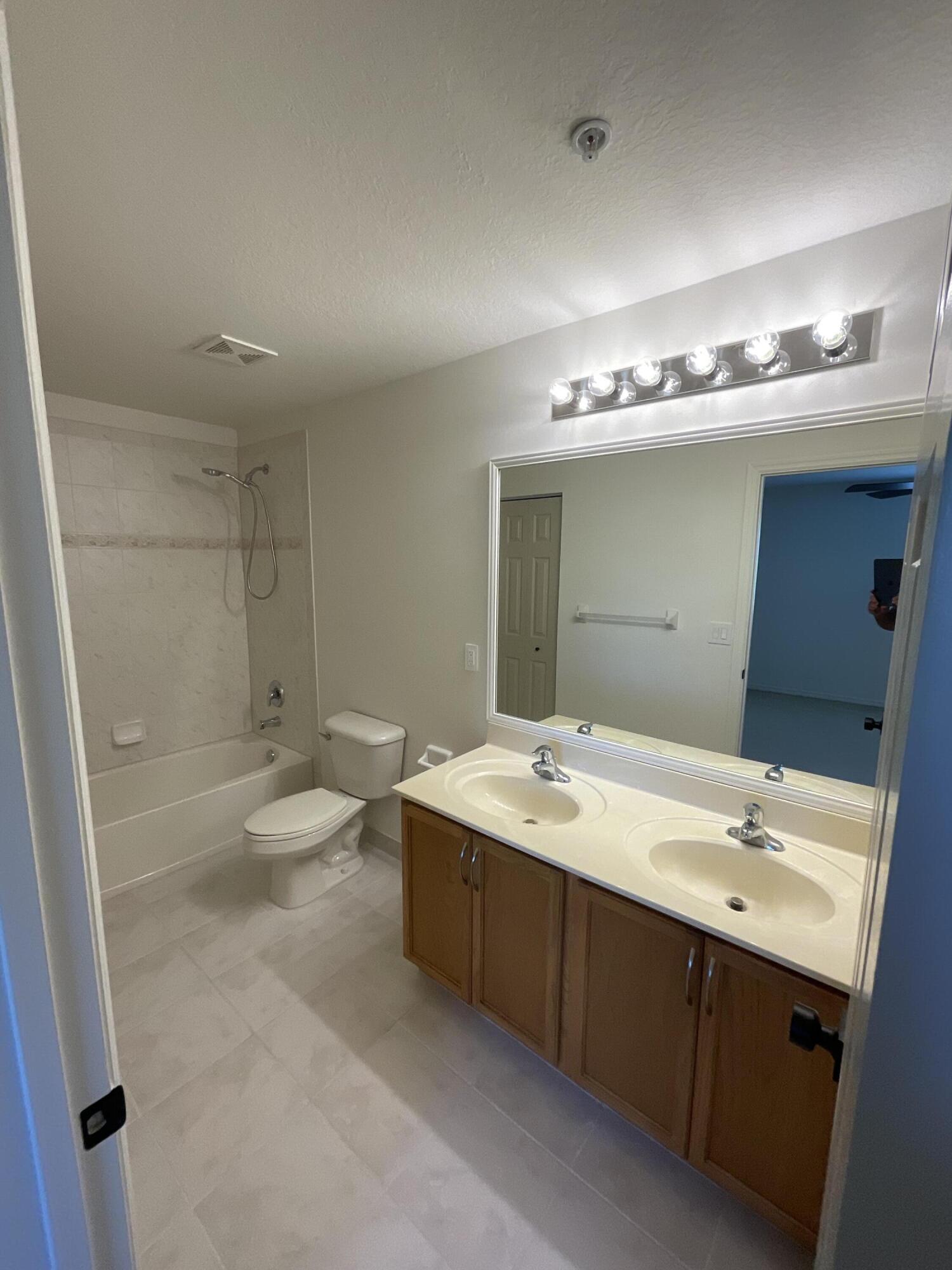5269 Southeast Jennings Lane Stuart, FL 34997 - Photo 21 of 34 a bathroom with a sink and a mirror