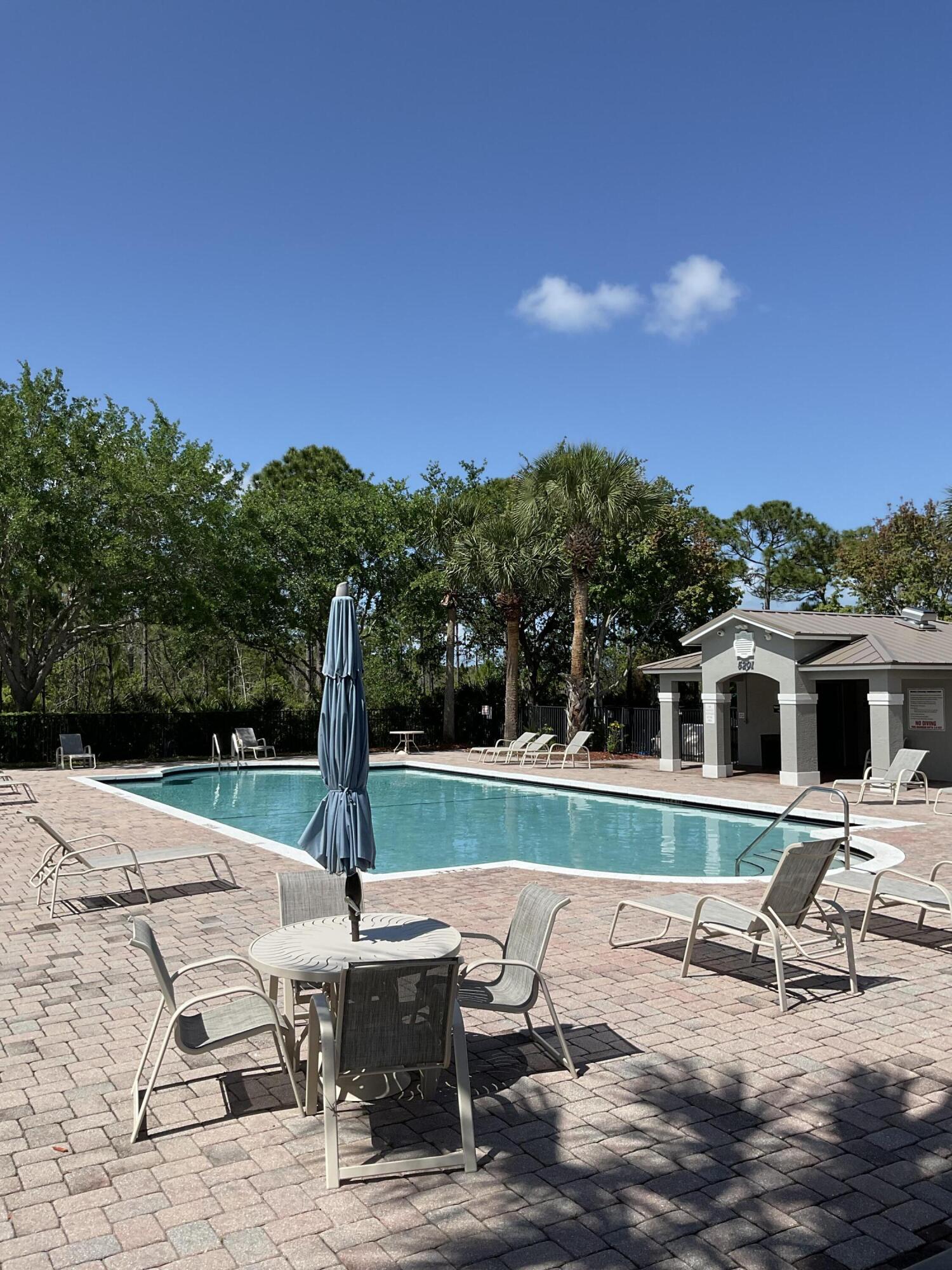 5269 Southeast Jennings Lane Stuart, FL 34997 - Photo 23 of 34 a view of a patio with chairs and a yard