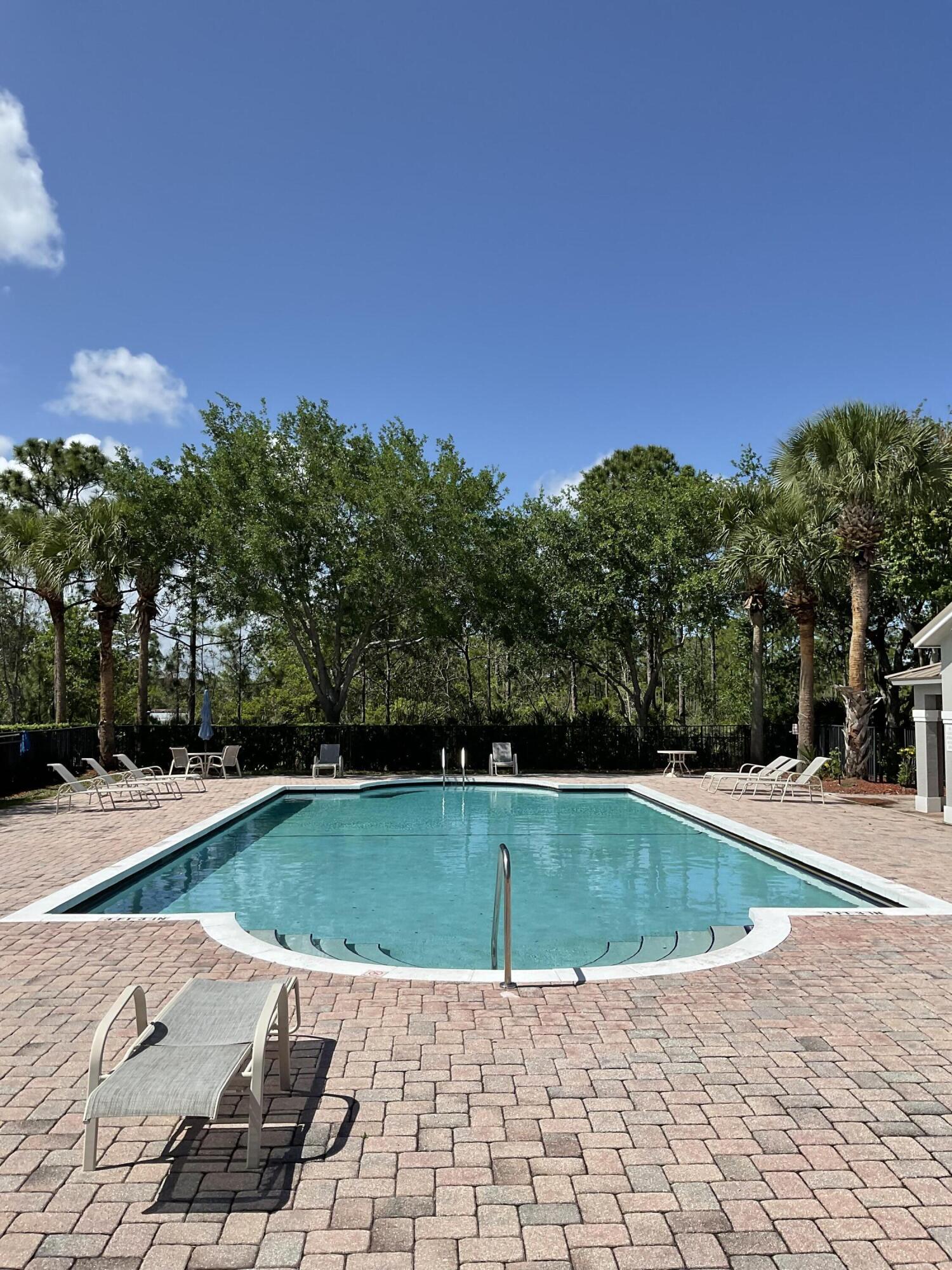 5269 Southeast Jennings Lane Stuart, FL 34997 - Photo 24 of 34 a view of a swimming pool with a yard