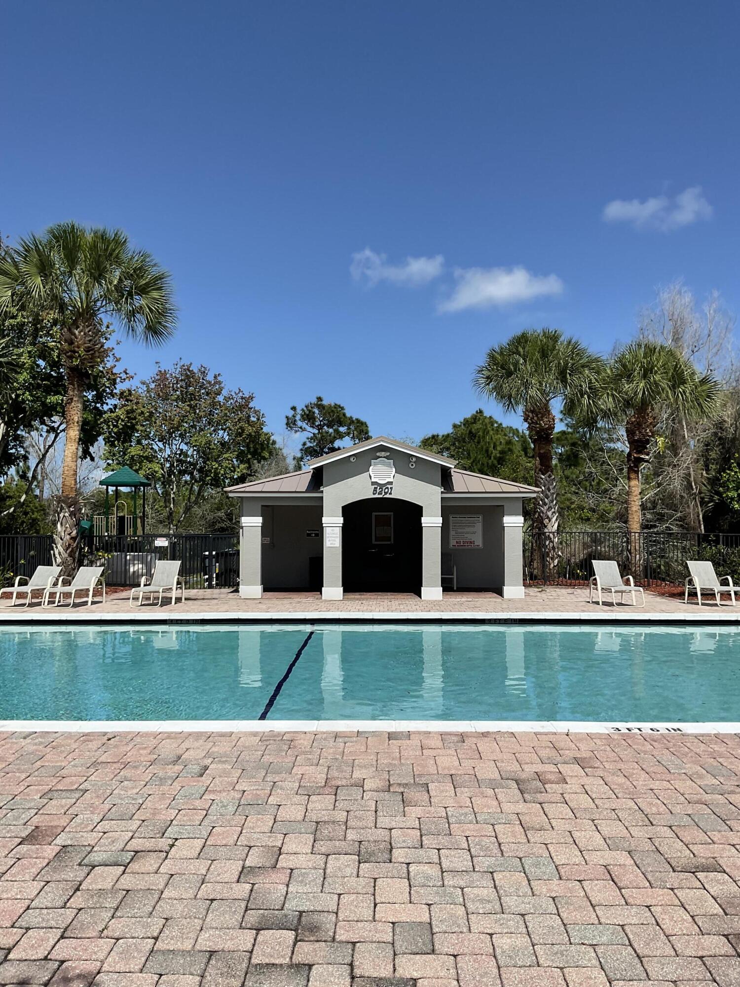 5269 Southeast Jennings Lane Stuart, FL 34997 - Photo 26 of 34 a view of a white house with a big yard and large trees