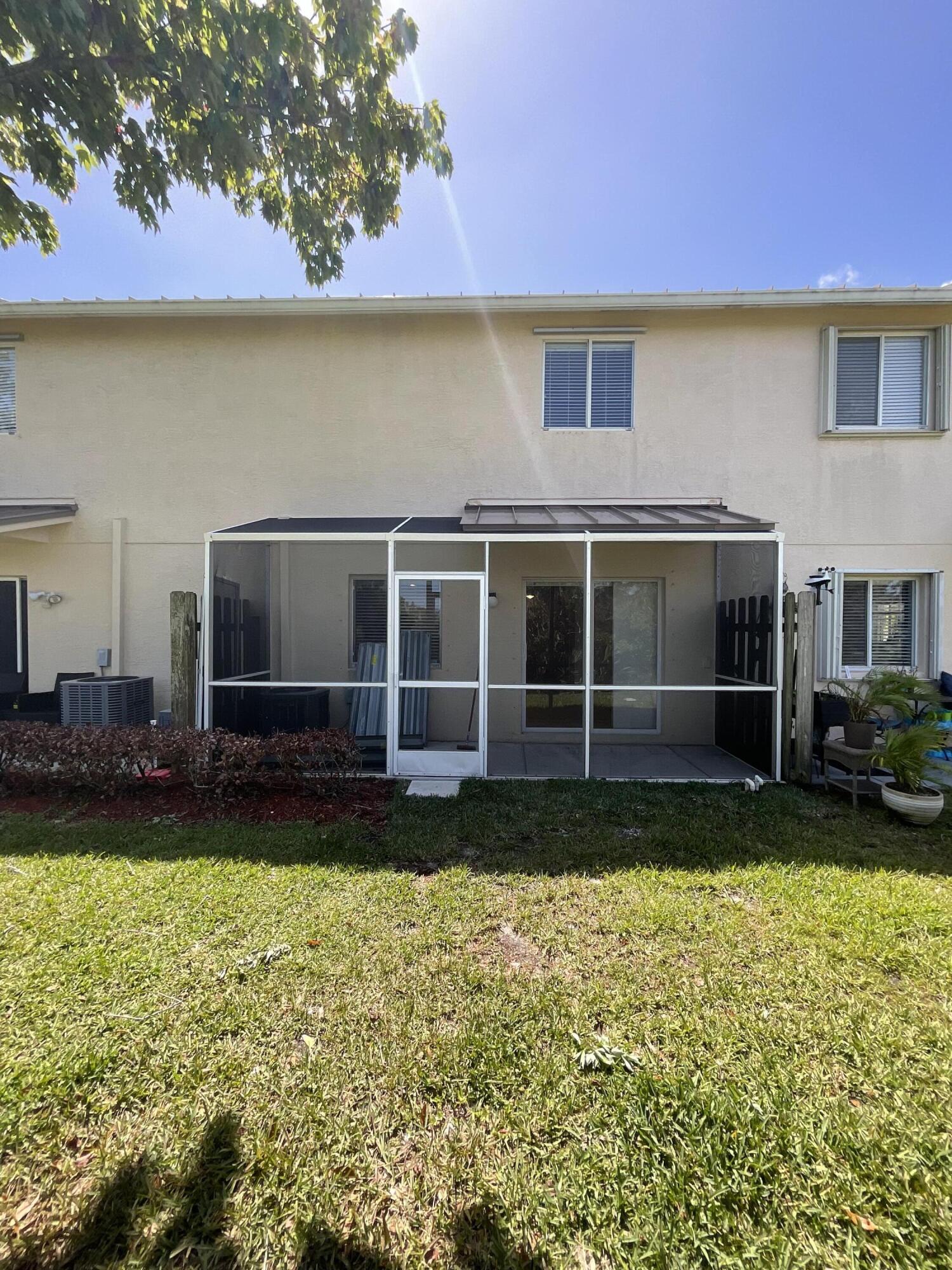 5269 Southeast Jennings Lane Stuart, FL 34997 - Photo 32 of 34 a view of a house with a yard and sitting area
