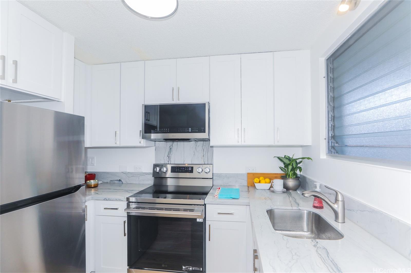 a kitchen with a sink a stove and a microwave