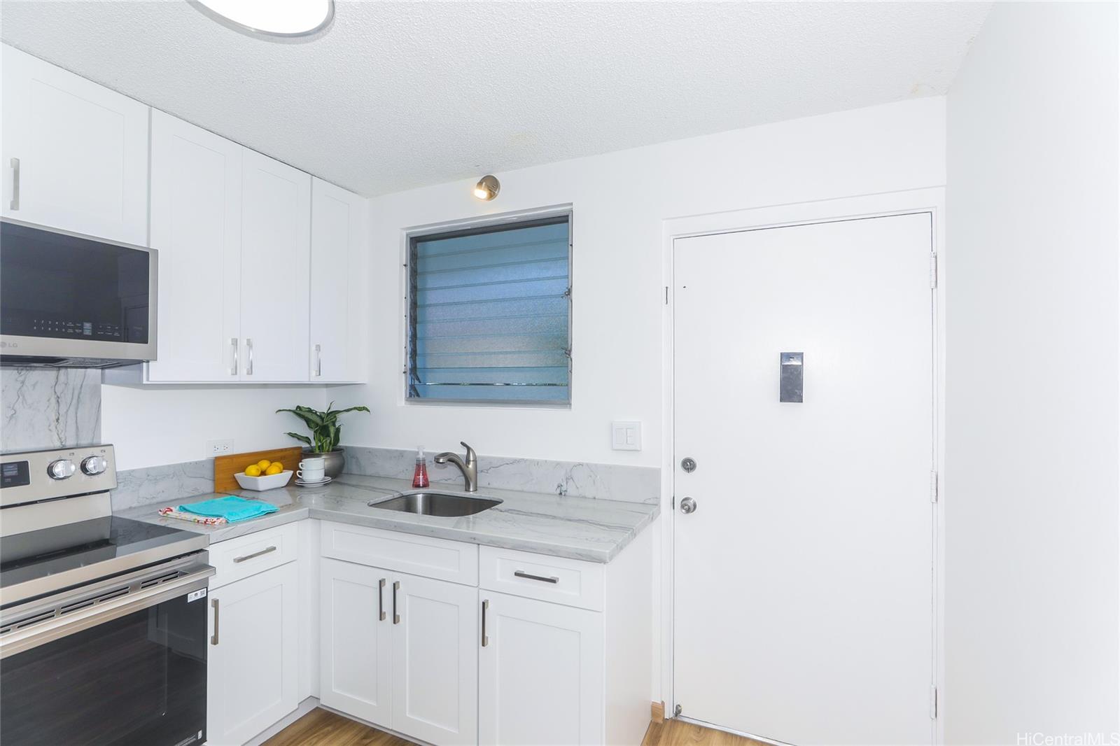 3095 Ala Ilima Street, Unit 204 Honolulu, HI 96818 - Photo 2 of 16 a kitchen with stainless steel appliances a sink stove and cabinets