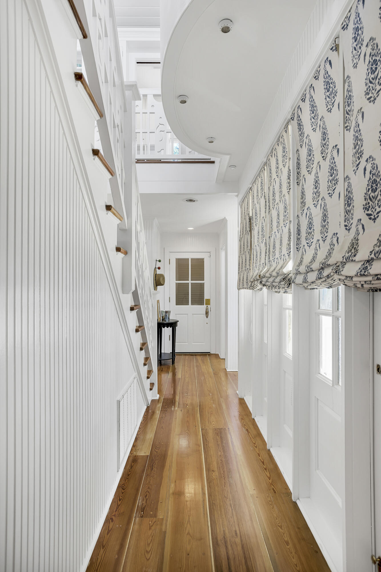 2040 East County Highway 30A Santa Rosa Beach, FL 32459 - Photo 41 of 51 a view of a hallway with wooden floor and staircase