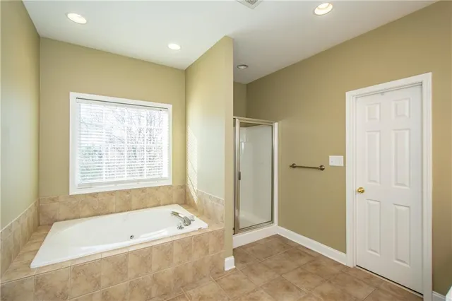 a bathroom with a tub a sink and a shower