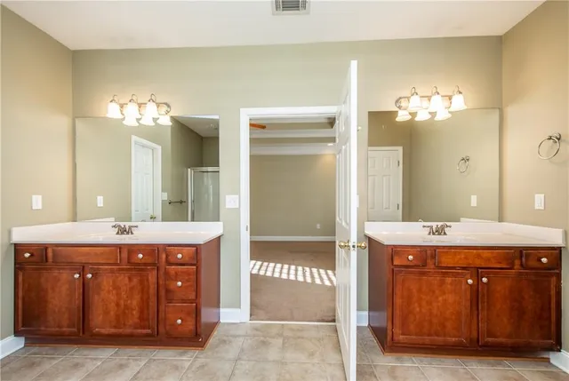 a bathroom with a double vanity sink and a mirror