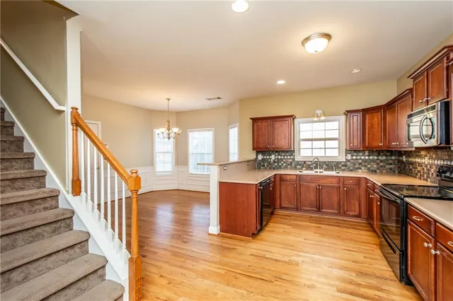 a kitchen with stainless steel appliances granite countertop a stove and a sink
