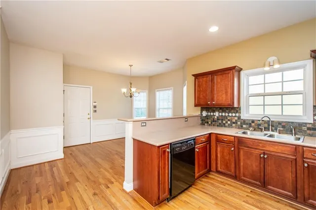 a kitchen with a sink stove and wooden cabinets