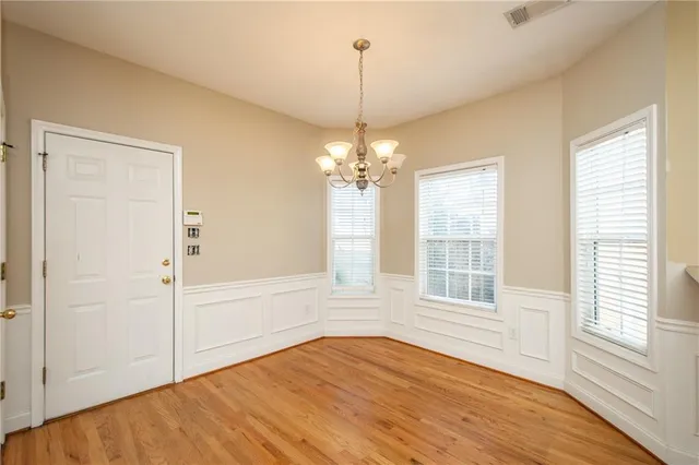 a view of a room with wooden floor and entryway