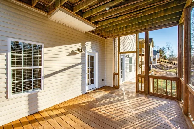 a view of a porch with wooden floor and a yard