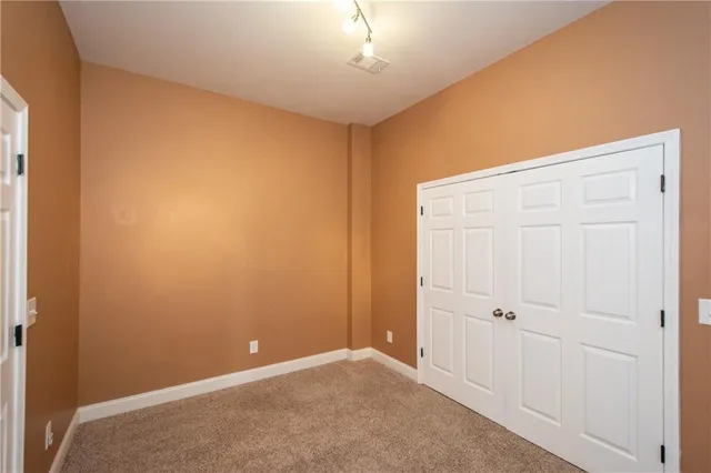 an empty room with closet area