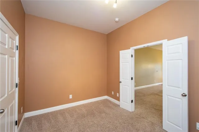 an empty room with an entrance to other room