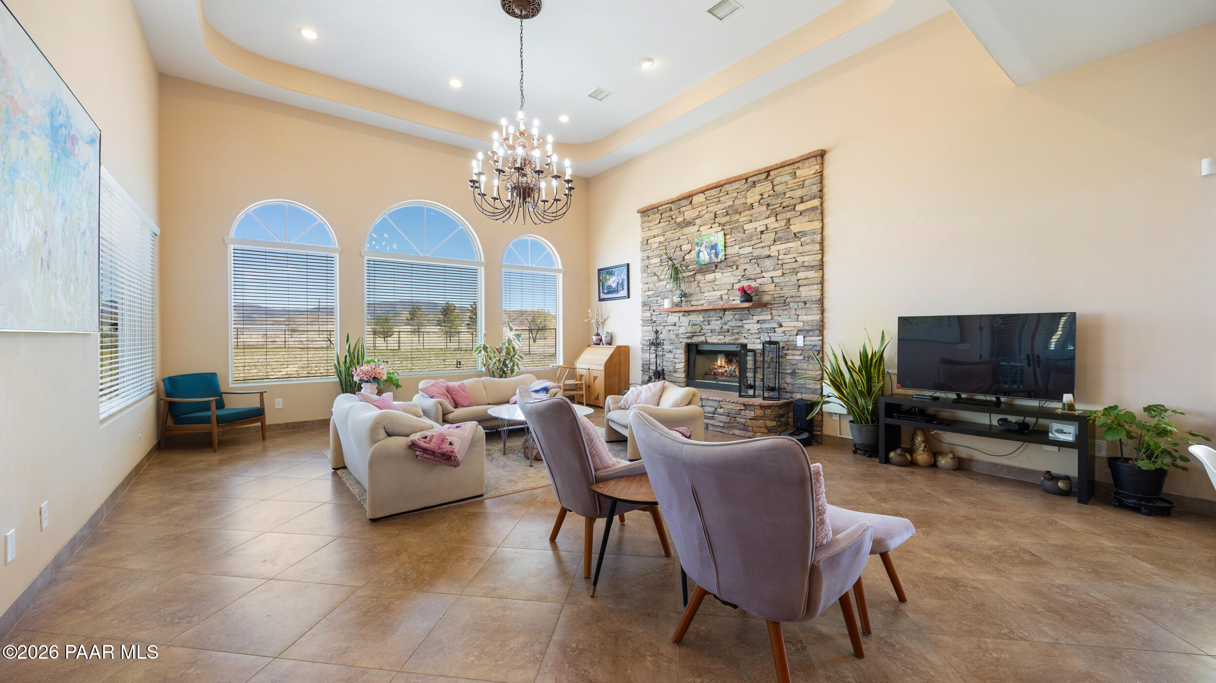 9605 North Coyote Springs Road Prescott Valley, AZ 86315 - Photo 11 of 43 a living room with fireplace furniture and a flat screen tv