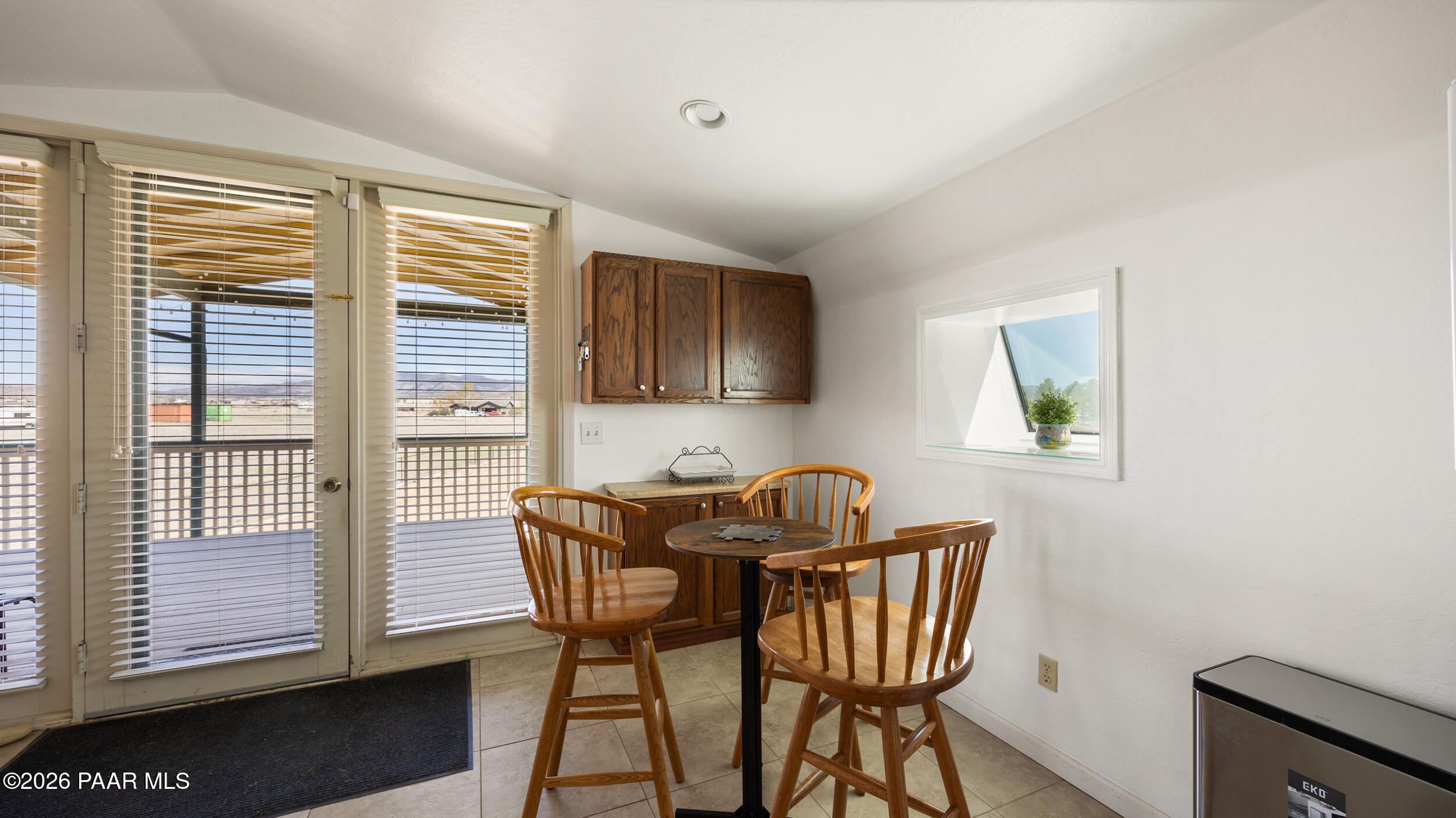 9605 North Coyote Springs Road Prescott Valley, AZ 86315 - Photo 24 of 43 a view of a dining room with furniture and windows