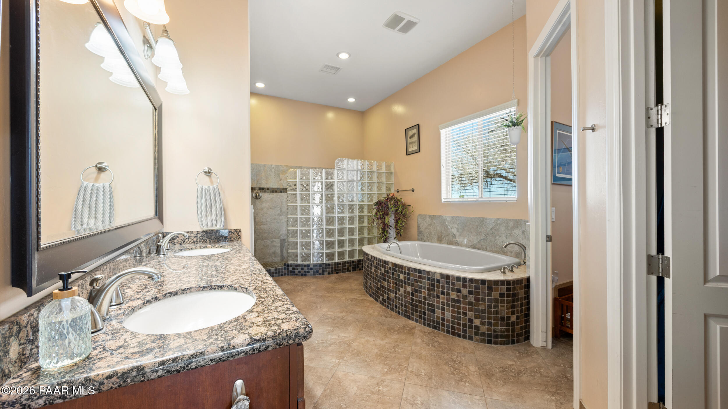9605 North Coyote Springs Road Prescott Valley, AZ 86315 - Photo 29 of 43 a bathroom with a granite countertop tub sink and mirror