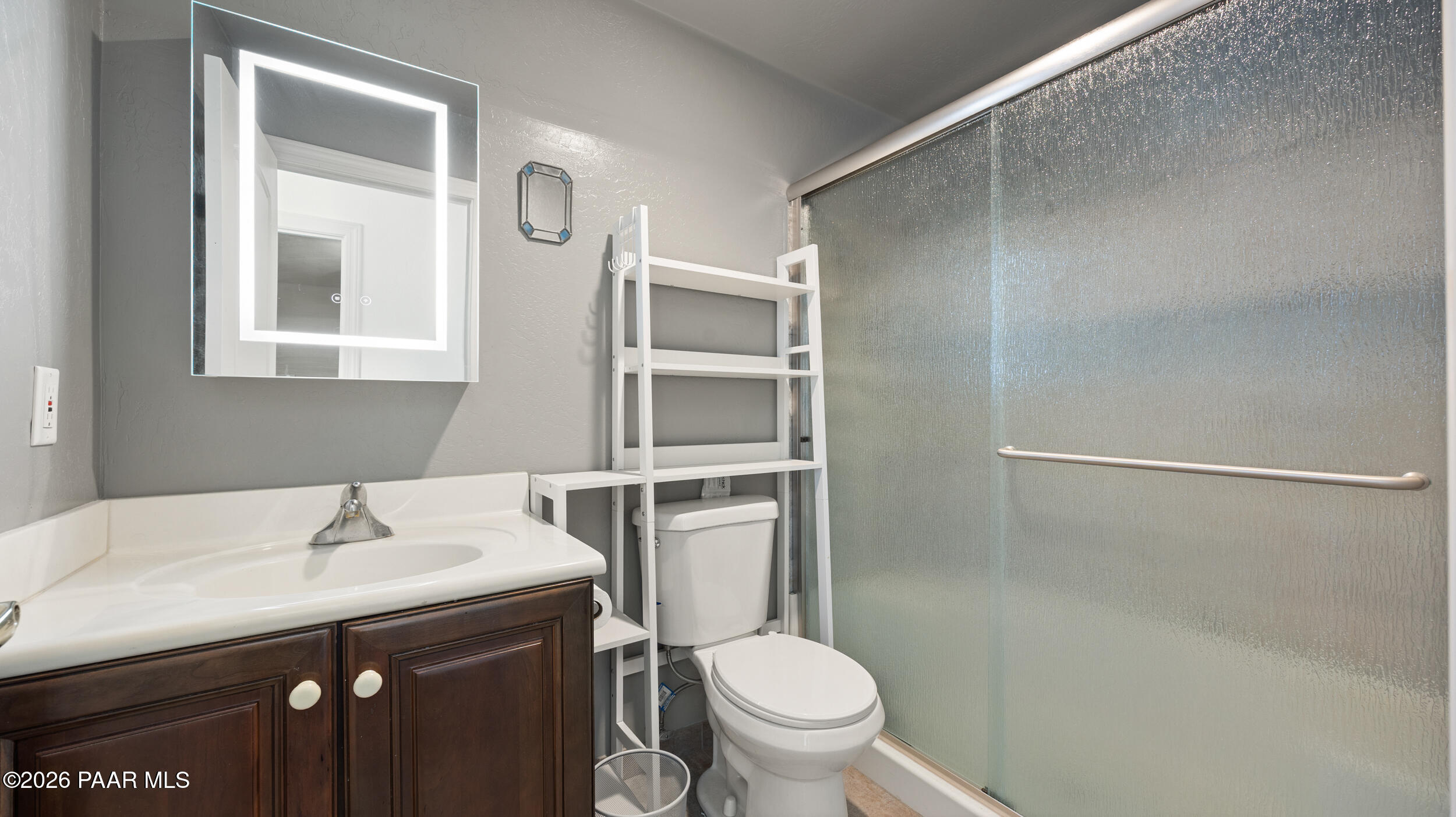 9605 North Coyote Springs Road Prescott Valley, AZ 86315 - Photo 37 of 43 a bathroom with a sink toilet and vanity