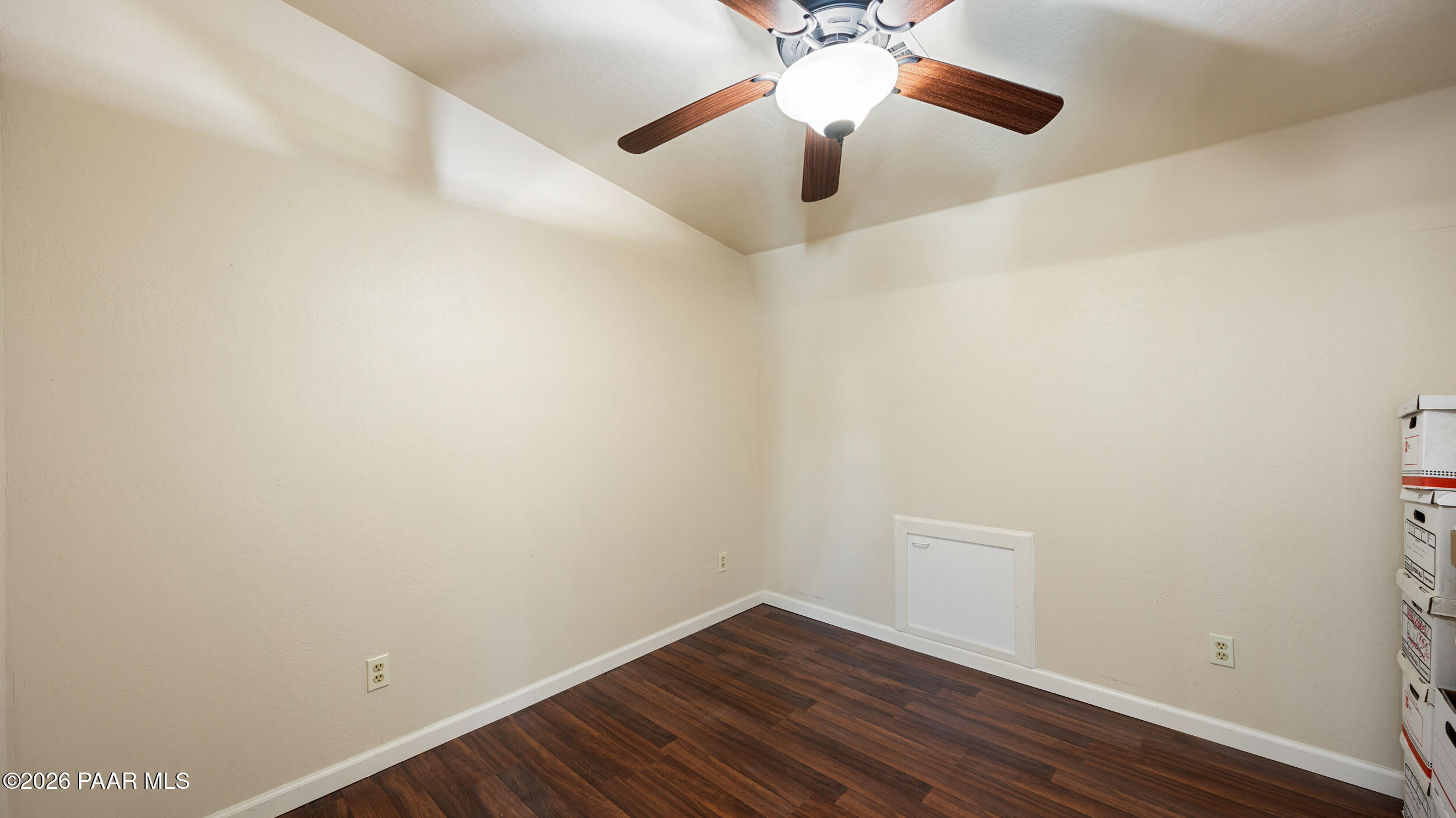 9605 North Coyote Springs Road Prescott Valley, AZ 86315 - Photo 39 of 43 an empty room with a hardwood and ceiling fan