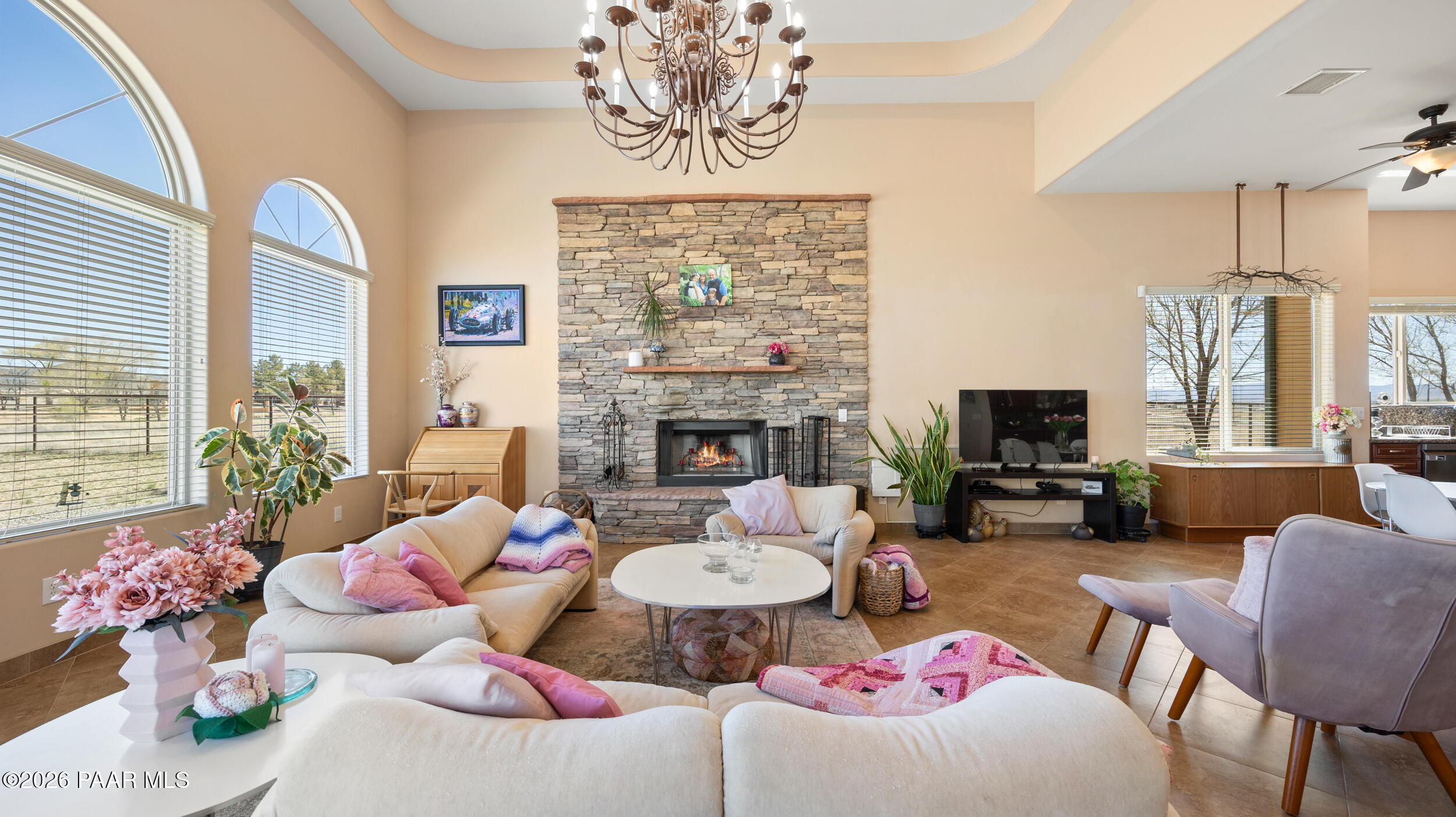 9605 North Coyote Springs Road Prescott Valley, AZ 86315 - Photo 10 of 43 a living room with furniture chandelier and a fireplace
