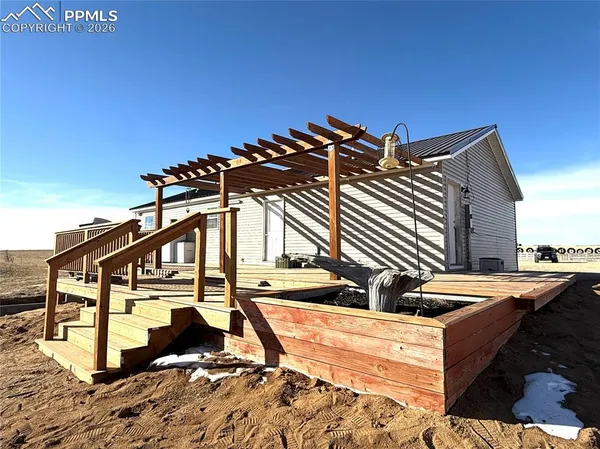 a view of a house with backyard and deck