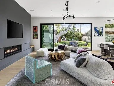 a living room with furniture rug and wooden floor