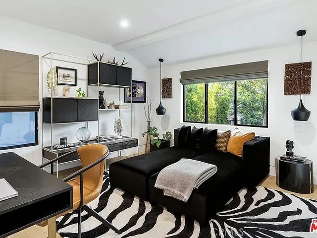 a view of a livingroom with furniture and a floor to ceiling window