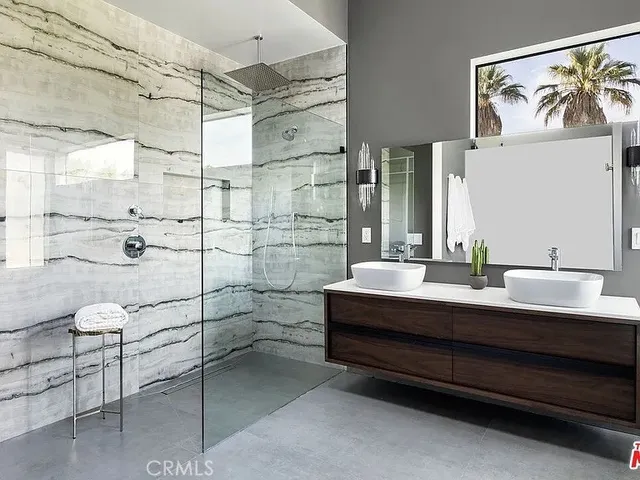 a bedroom with a bed and a closet with mirror