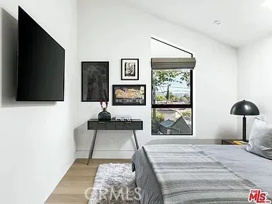 a bedroom with a bed and a potted plant