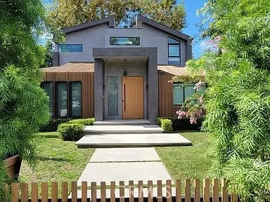 a front view of a house with a garden