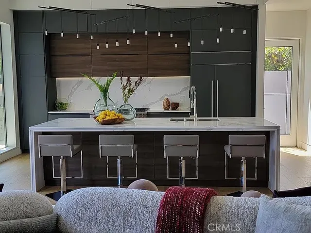 a living room with furniture a flat screen tv and floor to ceiling window