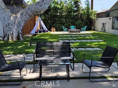 12132 Otsego Street Valley Village, CA 91607 - Photo 68 of 75 a backyard of a house with barbeque oven table and chairs